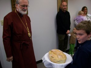 Michael presenting Bread to Bishop John